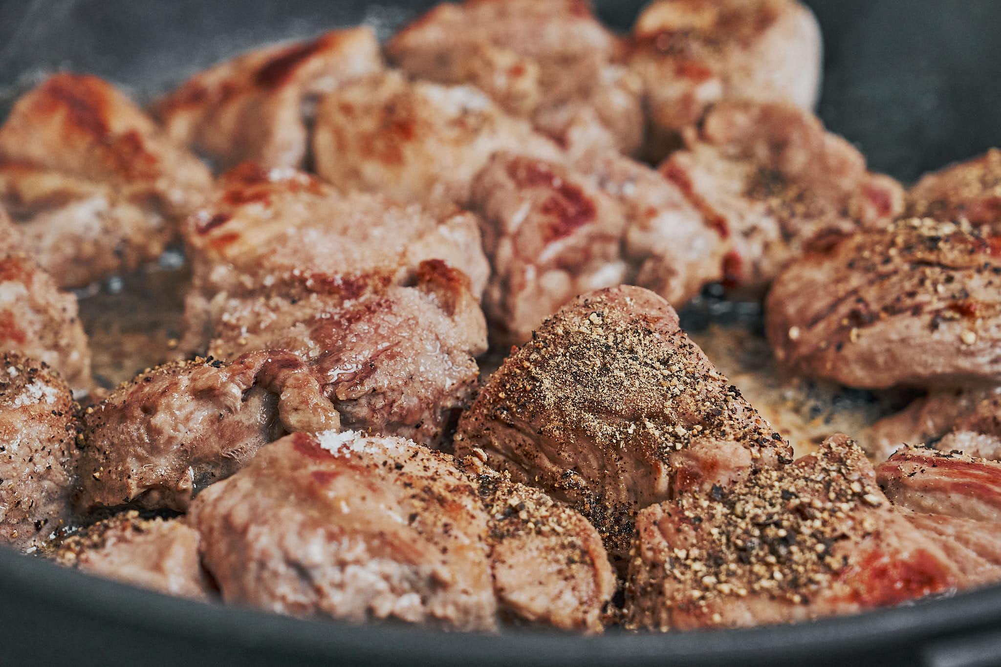 browned pork cubes seasoned with salt and pepper