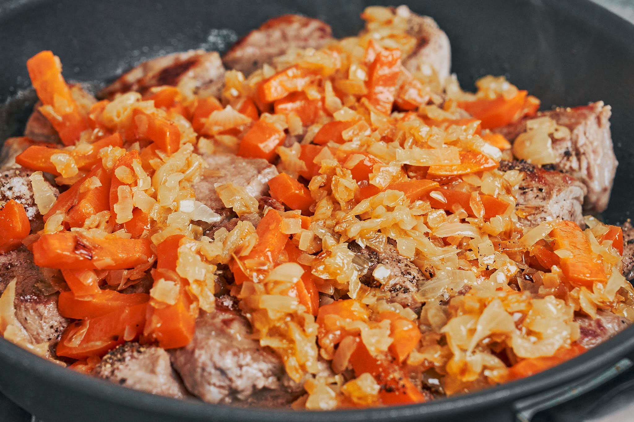 sauteed onions and carrots added back to browned pork