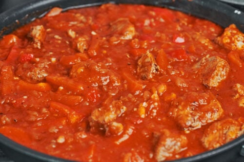 pork stew thickening as it cooks uncovered