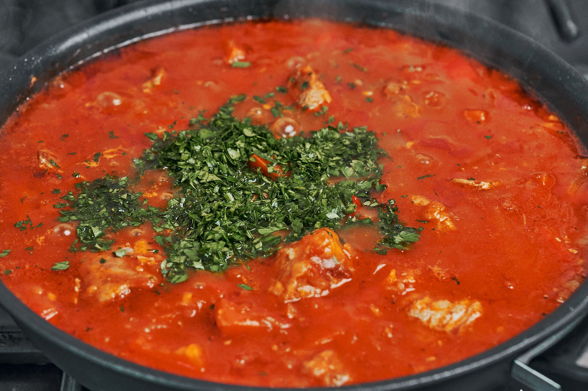 hearty pork stew with vegetables simmered in rich tomato sauce