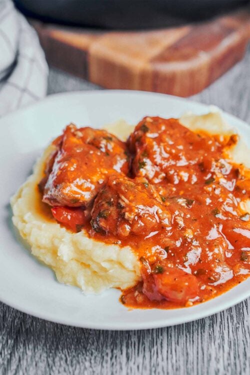 pork stew served over creamy mashed potatoes