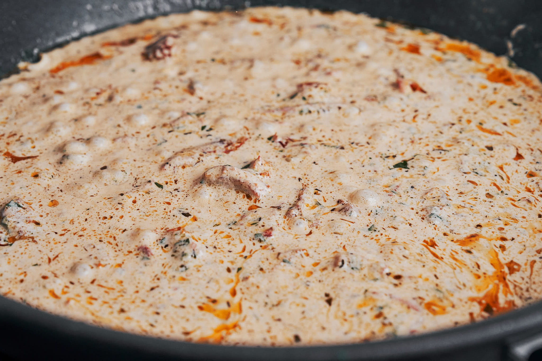 creamy sauce gently simmering until smooth and velvety