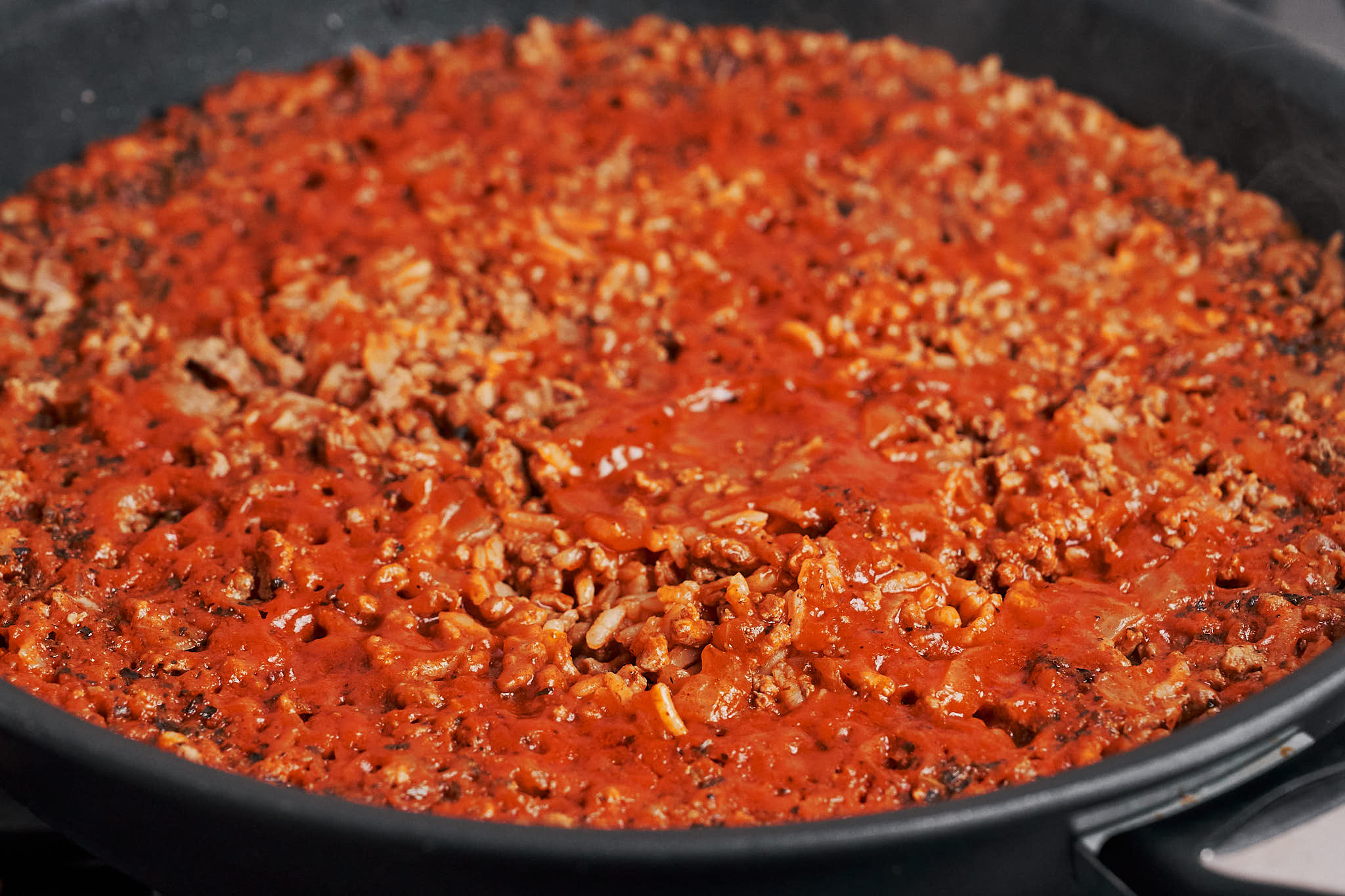 the beef and rice mixture simmering in a rich tomato sauce before the final creamy finish
