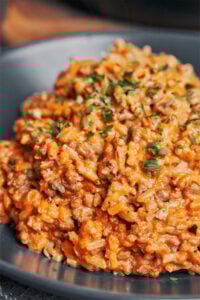 creamy tomato ground beef and rice skillet served warm with fresh parsley
