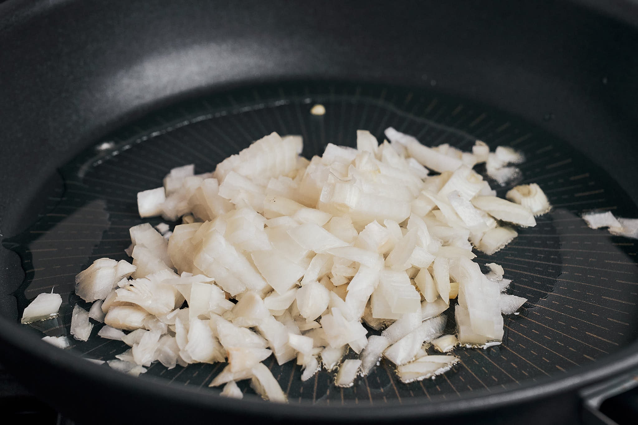 diced onion hitting the skillet and starting the flavor base for this cozy dinner