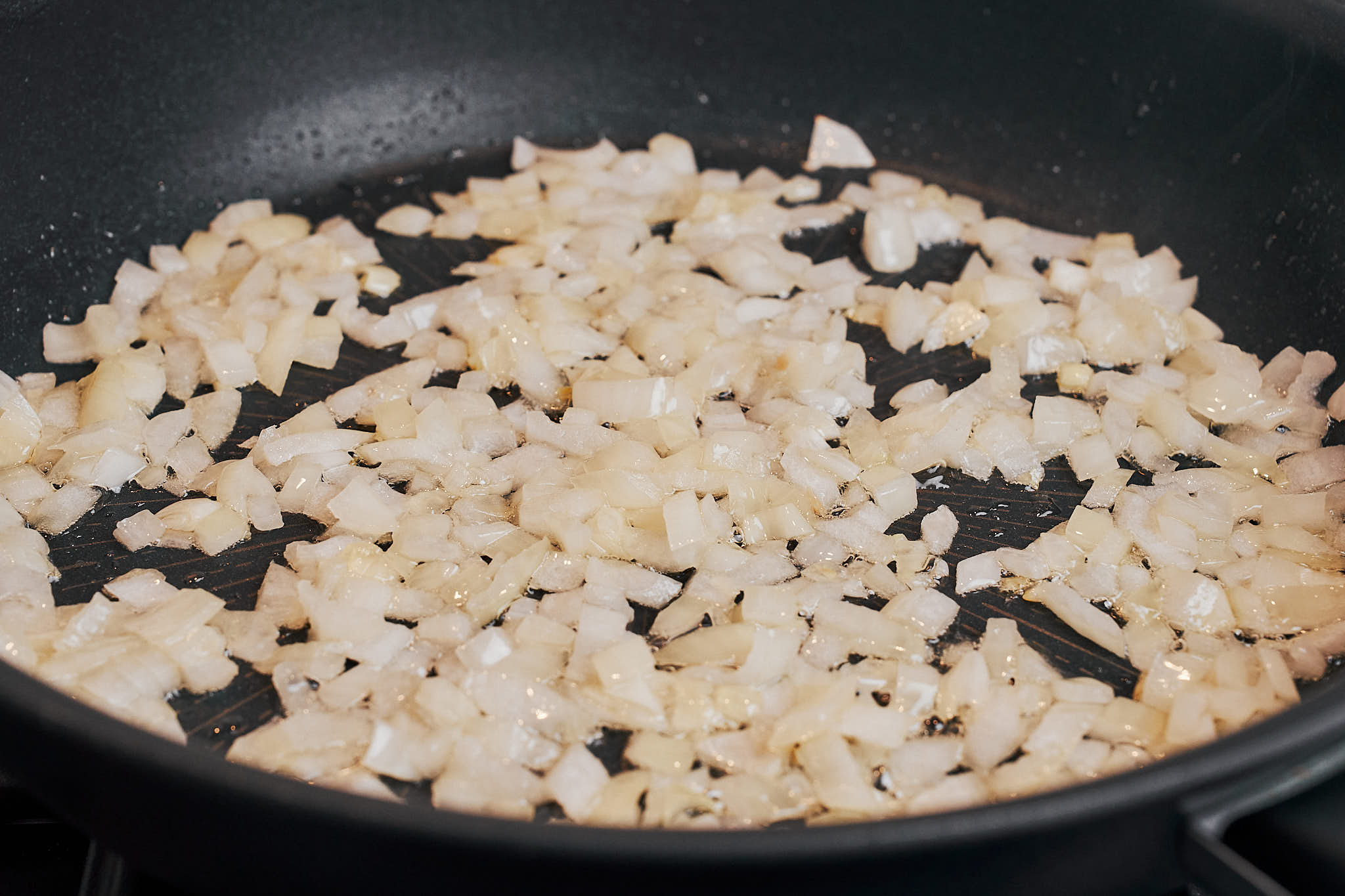 onion cooking down in the skillet until soft and lightly golden