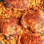 skillet chicken and rice with golden chicken thighs and fluffy rice