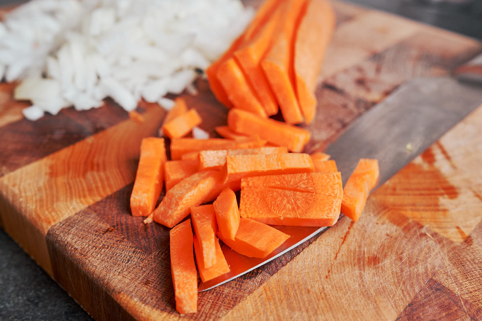 freshly chopped onion and sliced carrot ready to cook