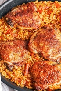 skillet chicken and rice with golden chicken thighs and fluffy rice