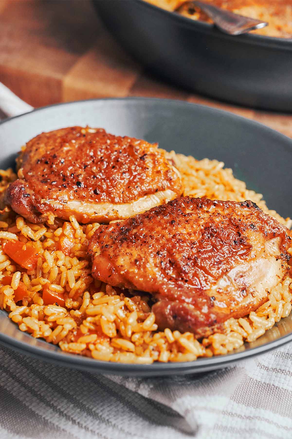 a cozy serving of chicken thighs with fluffy rice and carrots