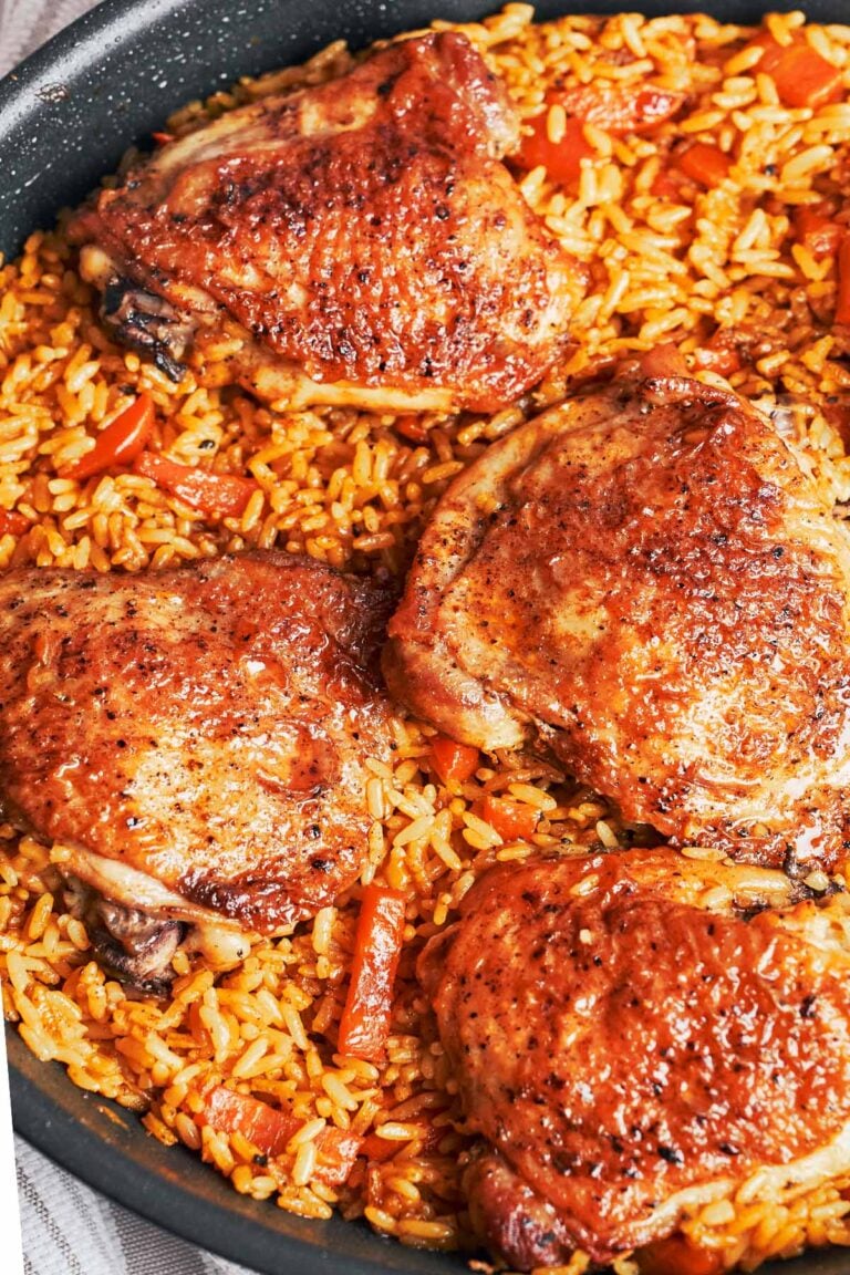 skillet chicken and rice with golden chicken thighs and fluffy rice