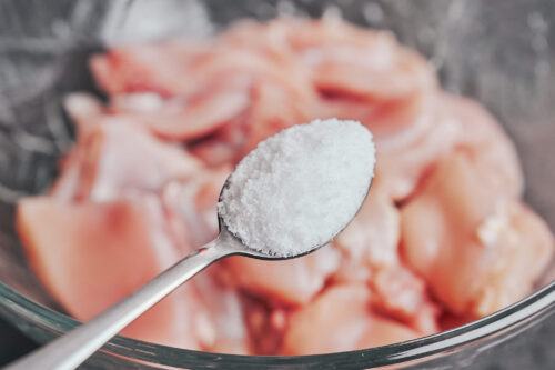 adding salt to chicken thighs