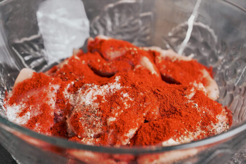 chicken thighs coated with paprika salt and pepper before cooking