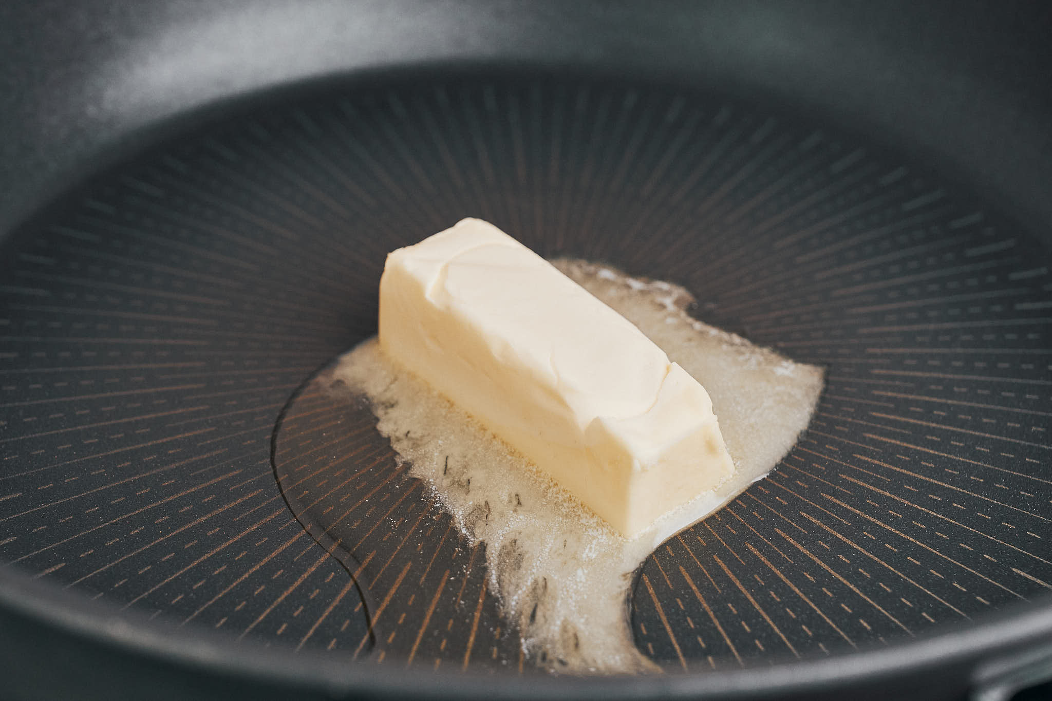 butter melting in a large skillet for paprika chicken recipe