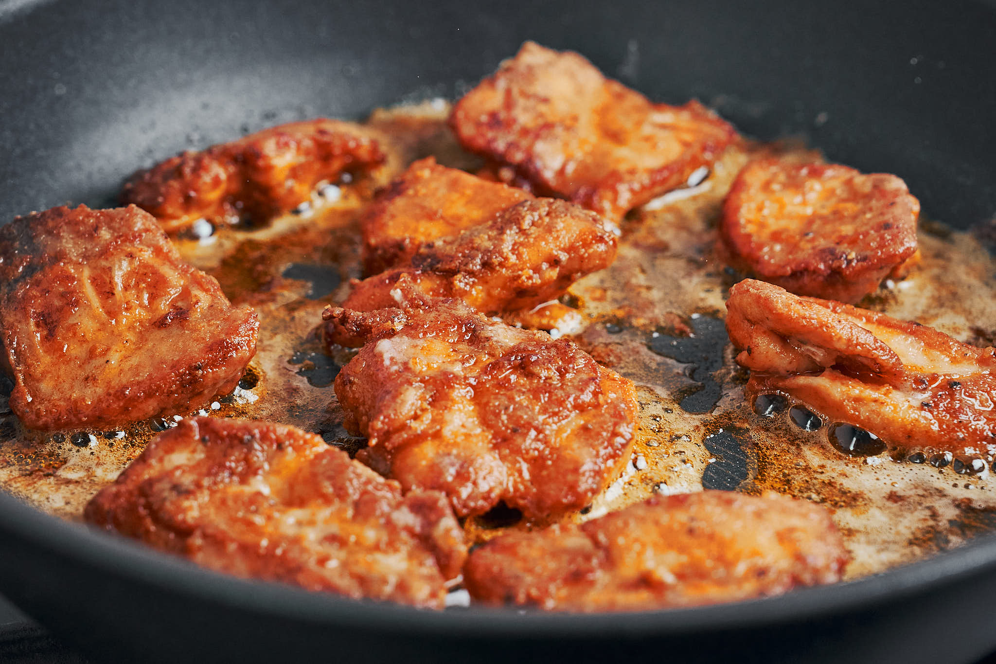 paprika chicken pieces browning in skillet with butter