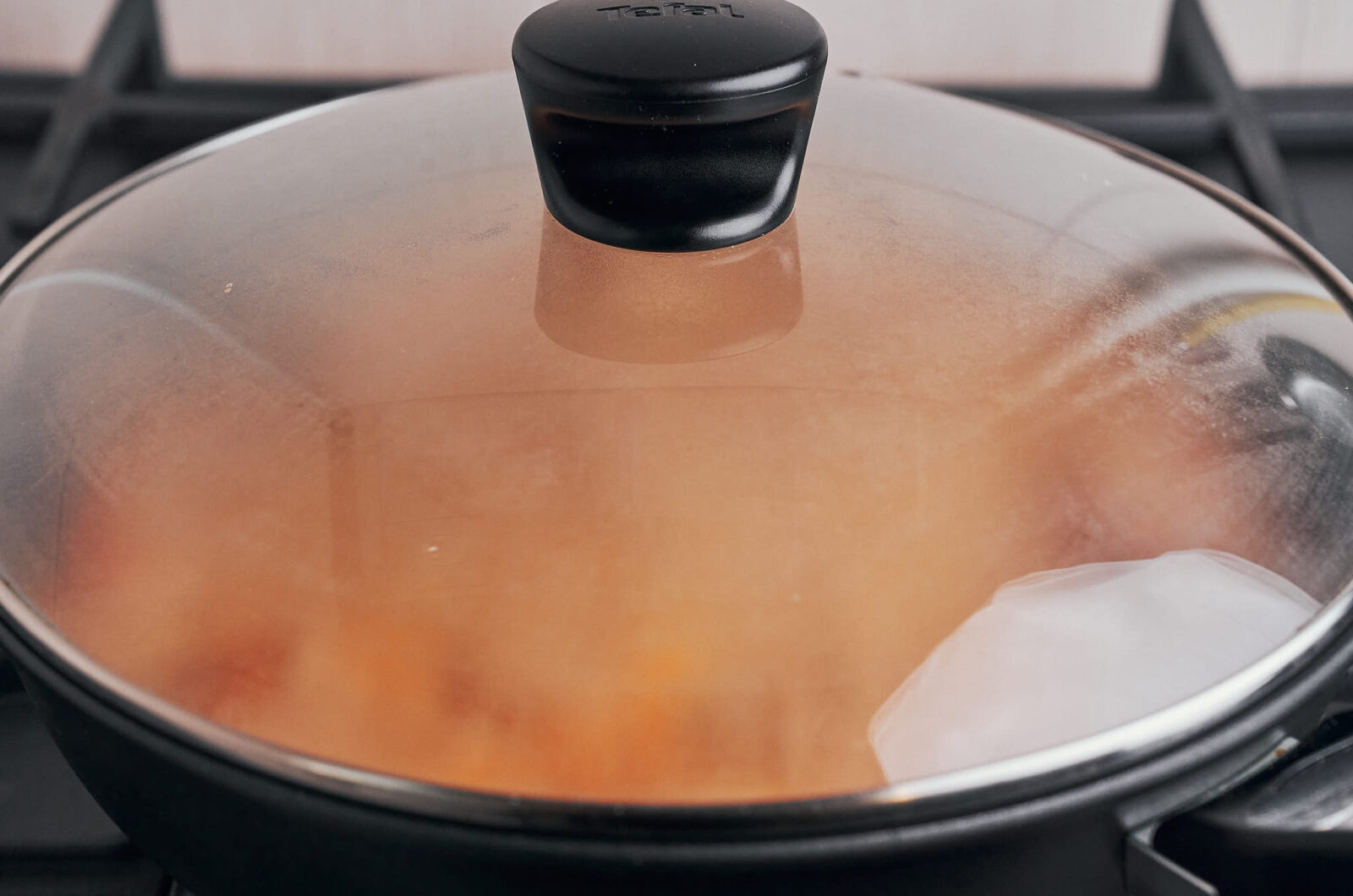 paprika chicken simmering covered in skillet