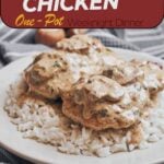 Juicy skillet chicken smothered in a creamy mushroom sauce on a cozy plate of rice