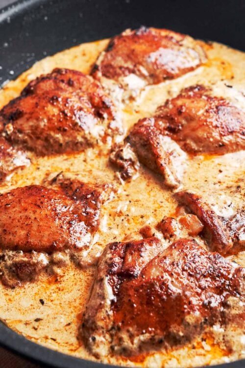 creamy Dijon chicken thighs finished in the skillet with a rich golden sauce