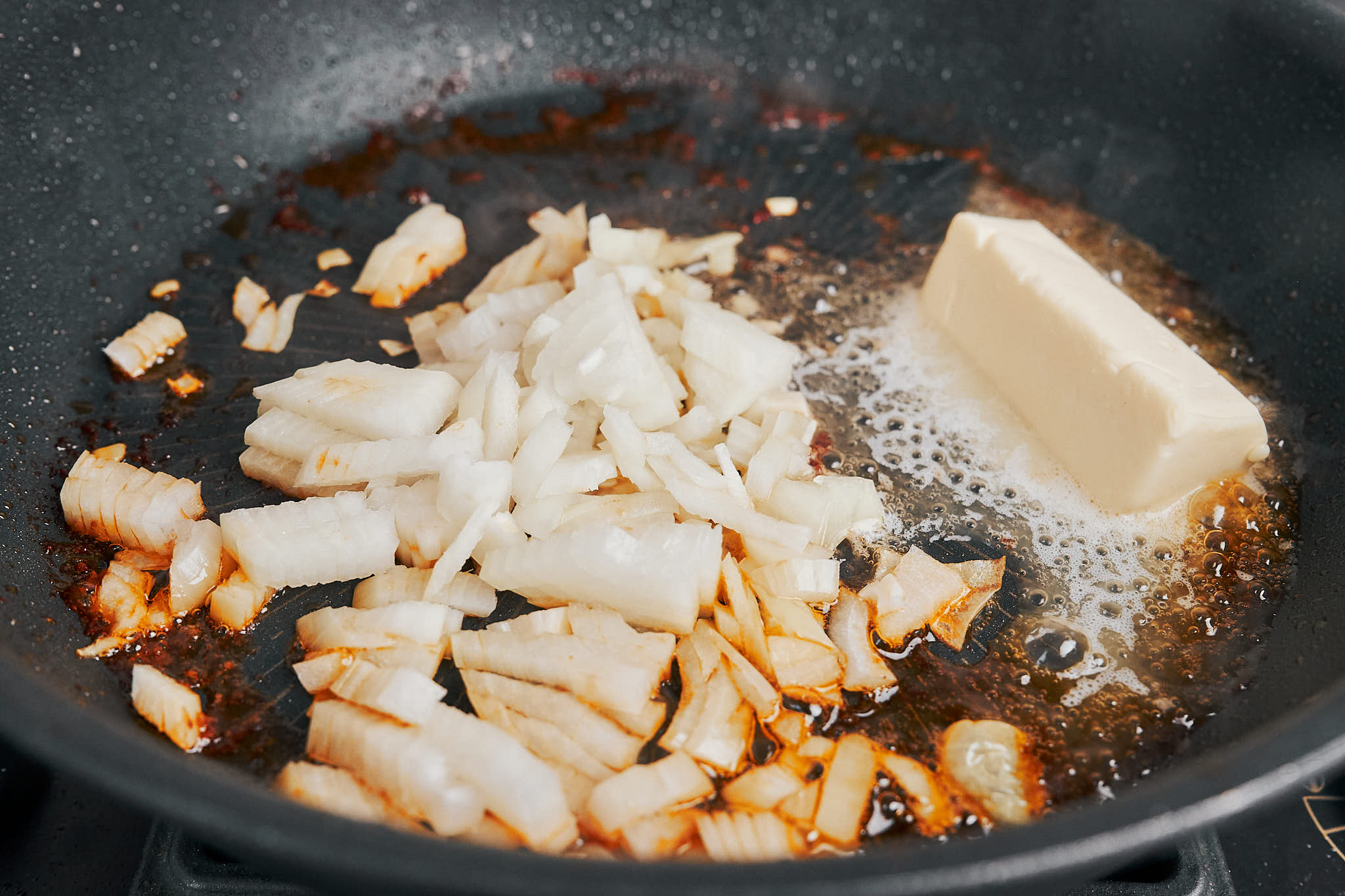 chopped onion melting into butter as the base of the creamy Dijon chicken sauce starts to build