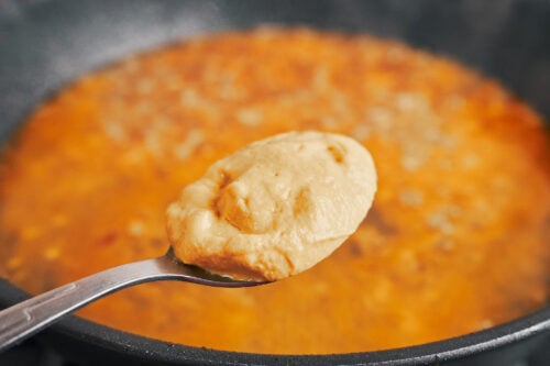 adding Dijon mustard to give the sauce its signature creamy tangy flavor