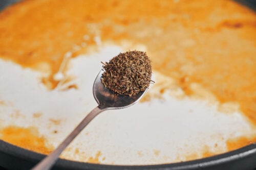 adding thyme to the creamy skillet sauce for a warm herby flavor