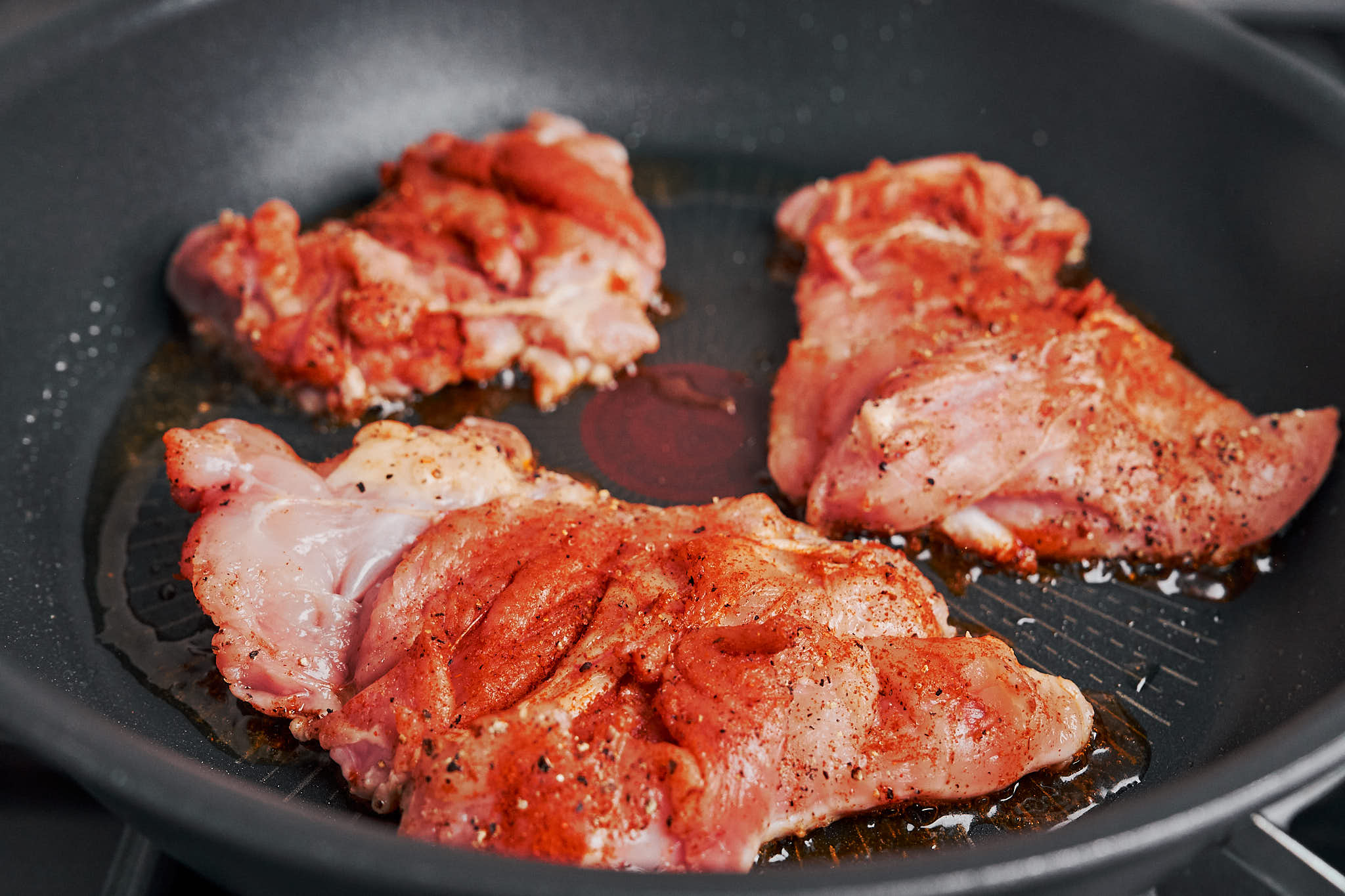 seasoned chicken thighs sizzling in the pan as the creamy Dijon chicken comes together