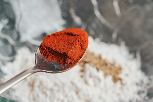 adding paprika to the flour mixture to give the chicken a warm, flavorful coating
