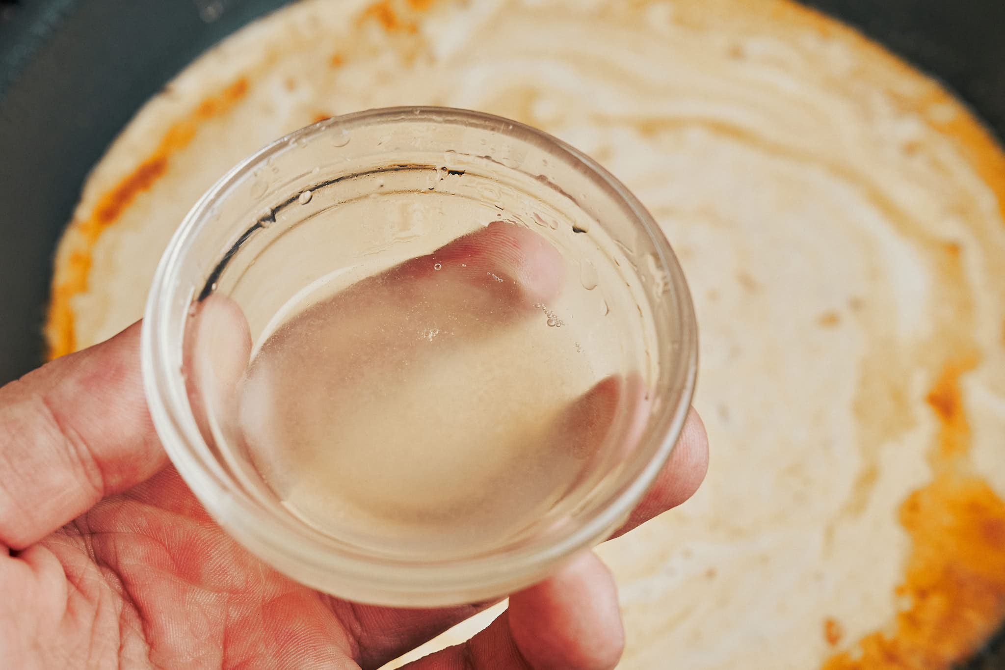 stirring fresh lemon juice into the creamy lemon chicken sauce