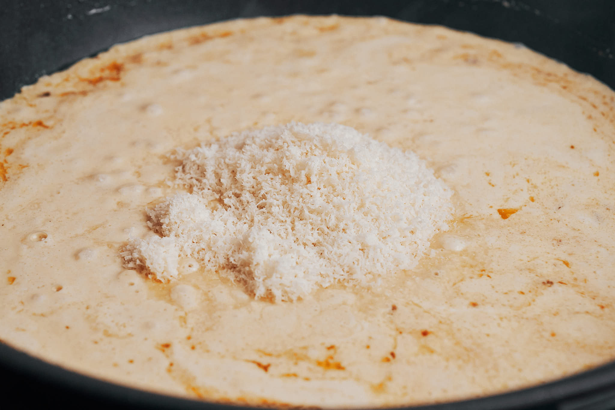 grated parmesan melting into the creamy lemon chicken sauce