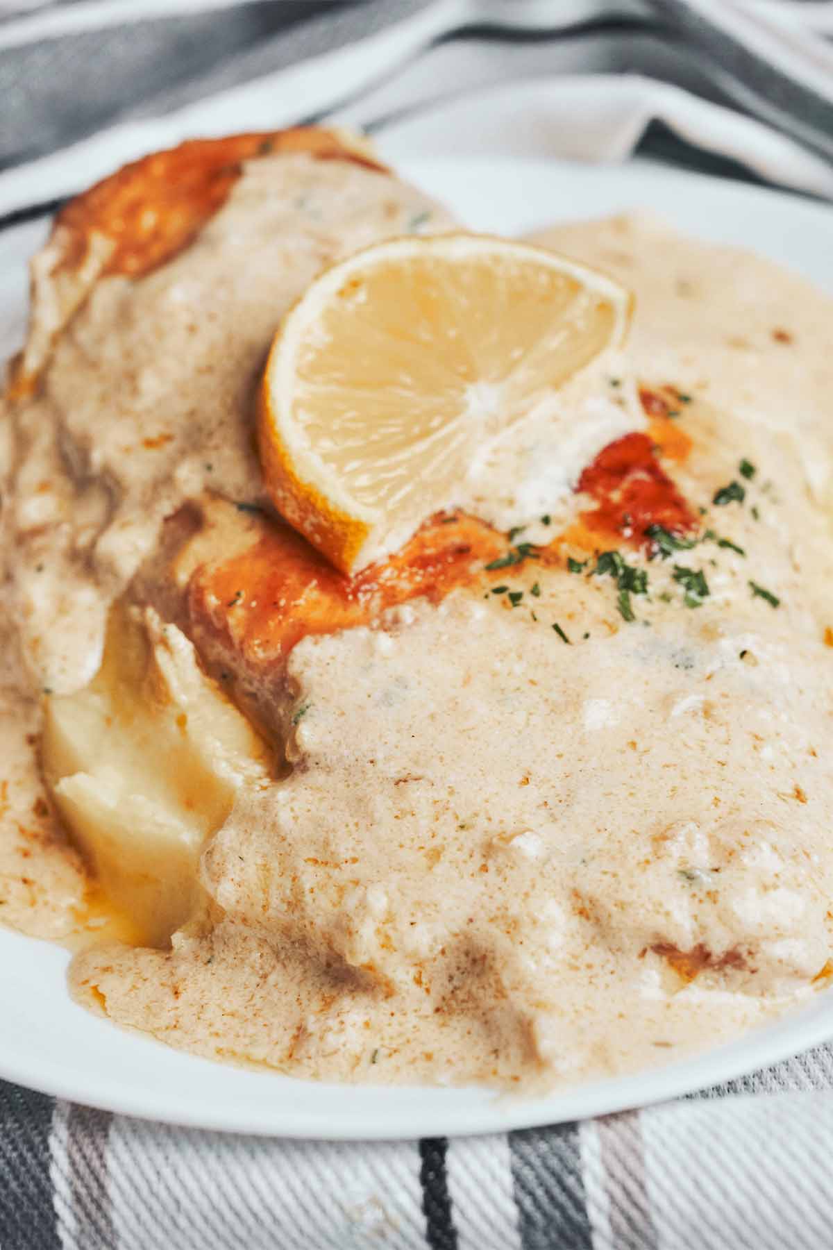 creamy lemon chicken with extra lemon cream sauce served over mashed potatoes
