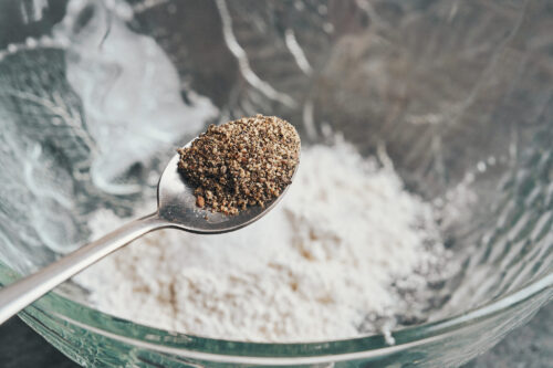 adding freshly ground black pepper to the flour mixture for the chicken coating