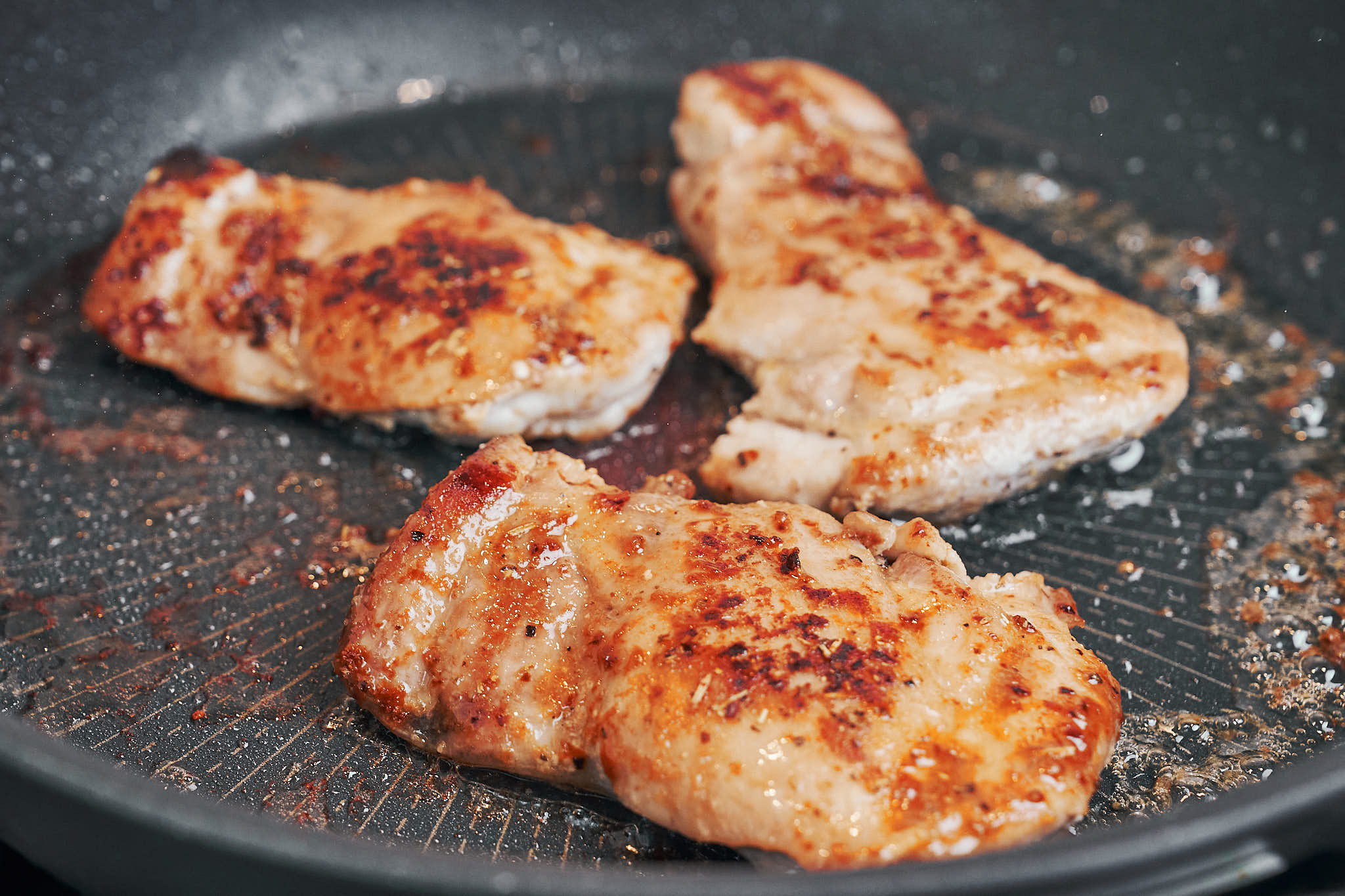 golden seared chicken thighs in a skillet