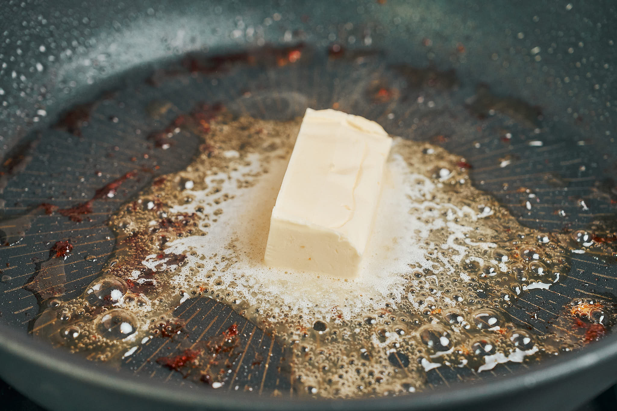 butter melting in a pan to cook mushrooms