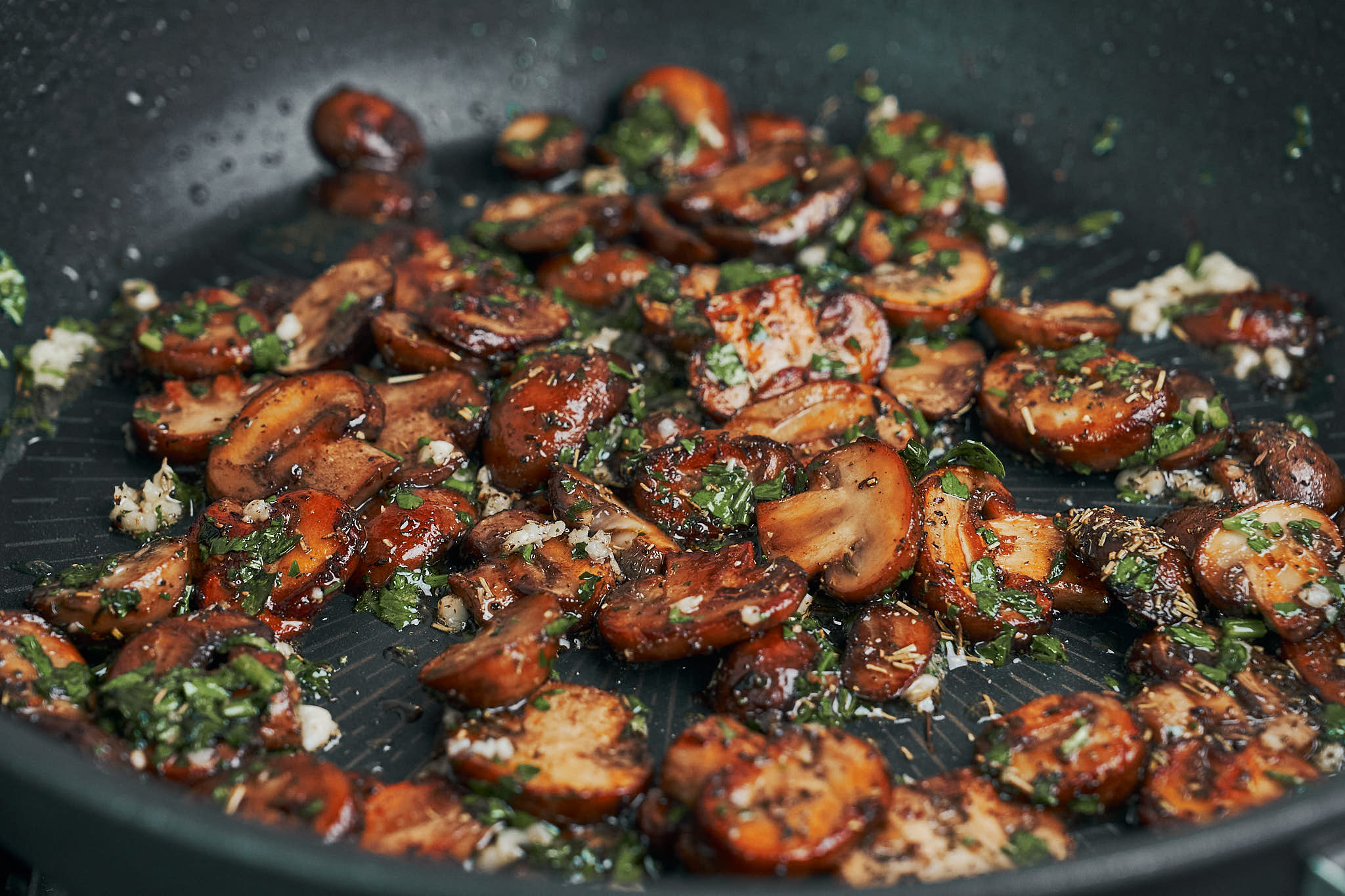 sautéed mushrooms with garlic and parsley in a skillet