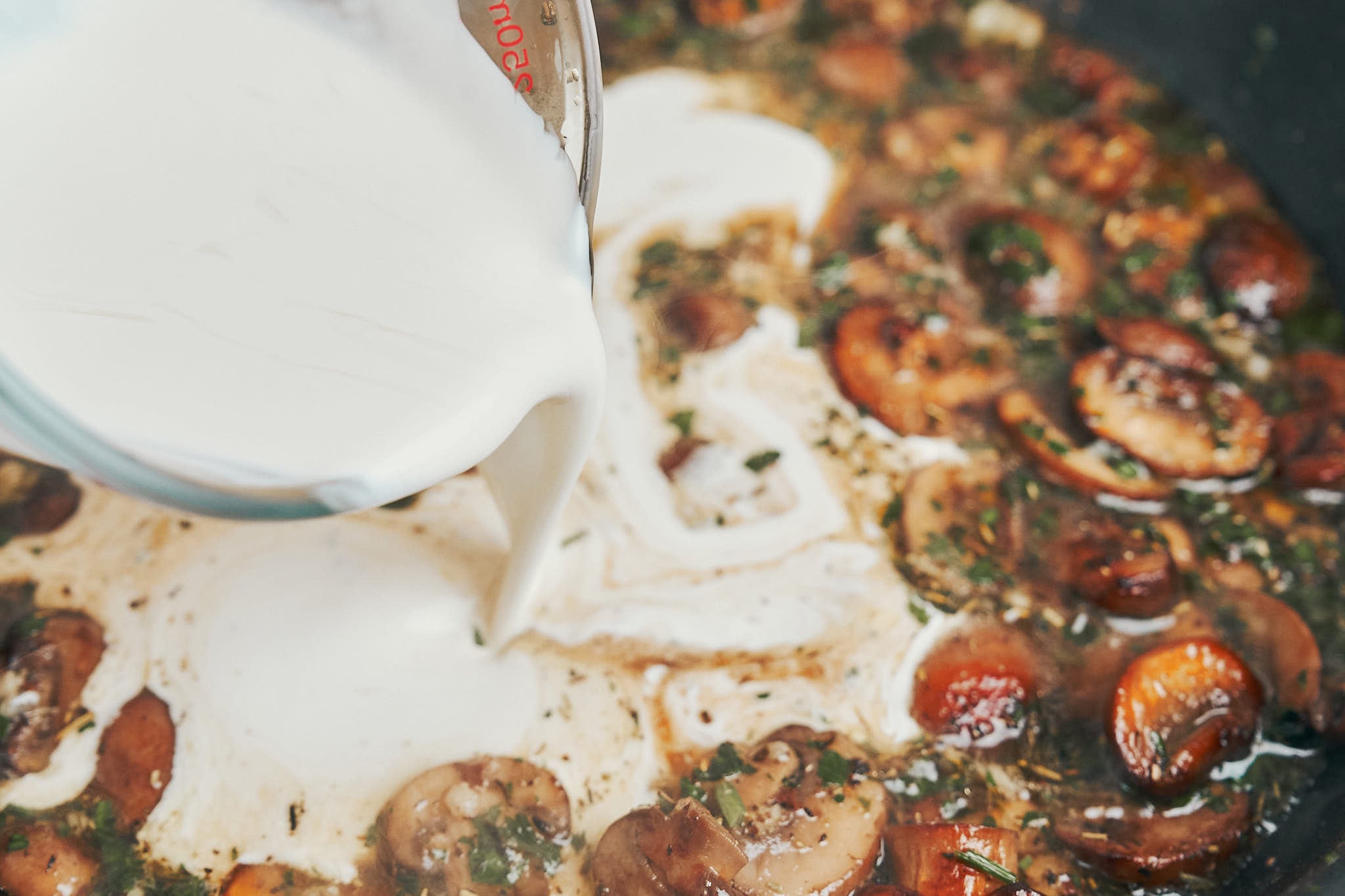 adding heavy cream to mushrooms to make cream sauce
