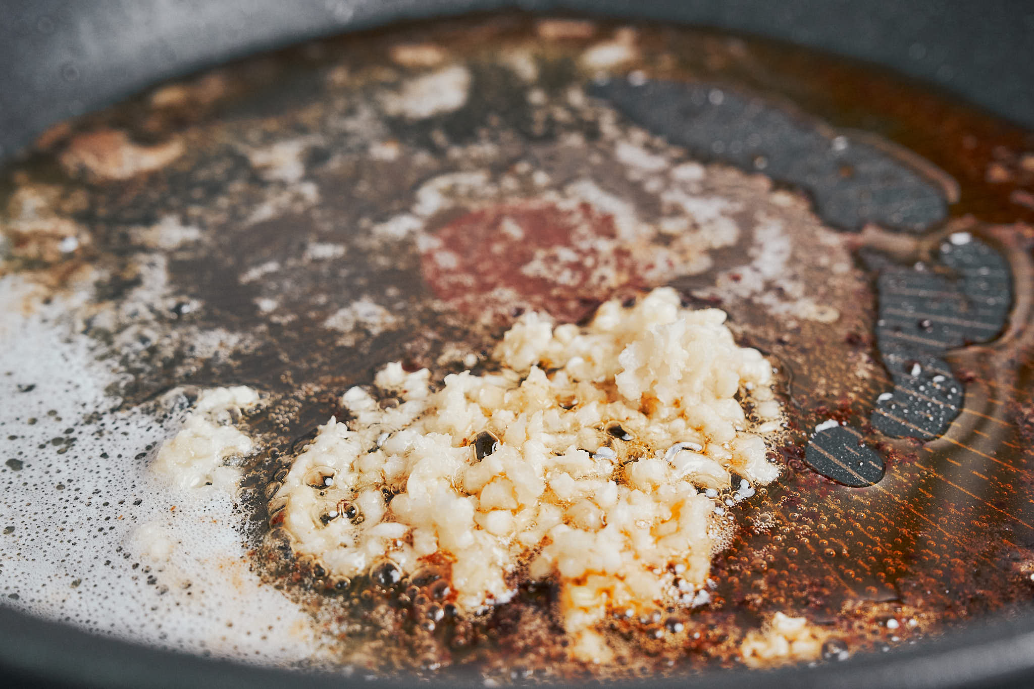 garlic cooking in butter to build flavor for the sauce