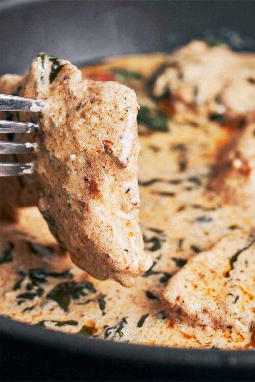 tender chicken coated in creamy spinach parmesan sauce