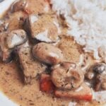 creamy beef stew with tender chunks of beef, mushrooms and carrots served over rice
