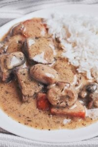 creamy beef stew with tender chunks of beef, mushrooms and carrots served over rice