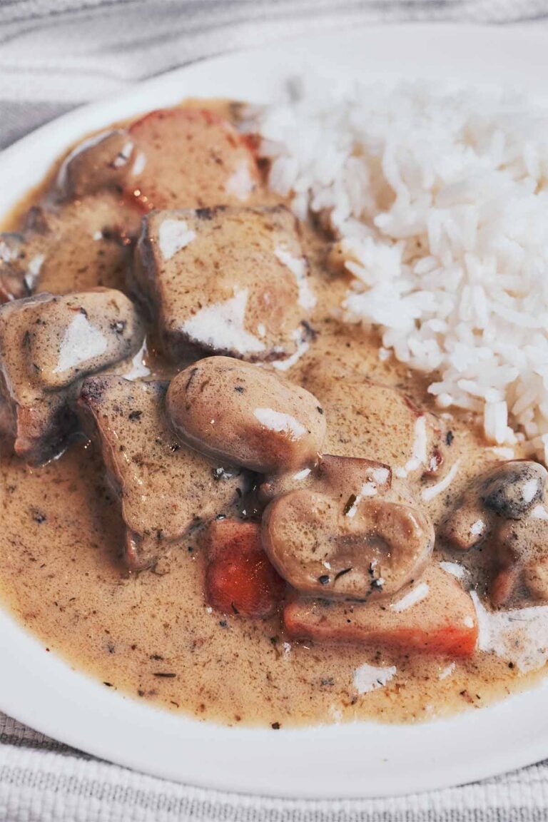 creamy beef stew with tender chunks of beef, mushrooms and carrots served over rice
