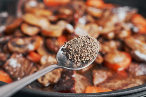 adding black pepper to deepen the flavor of the stew