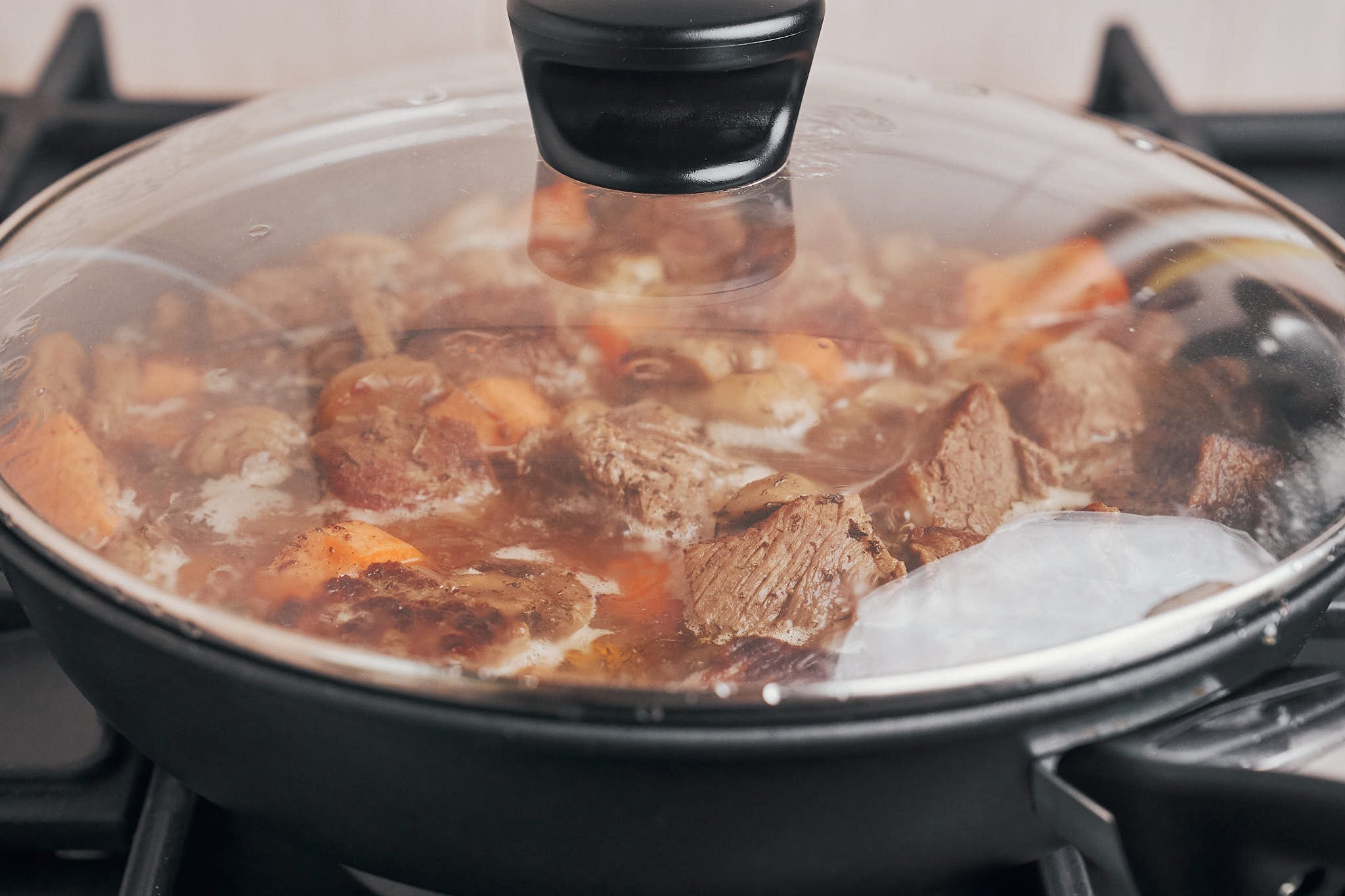 letting the beef stew cook slowly under the lid