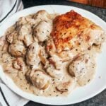 Creamy French chicken with potatoes and bacon in a rich Dijon white wine sauce, served warm with golden chicken thighs and tender potatoes.