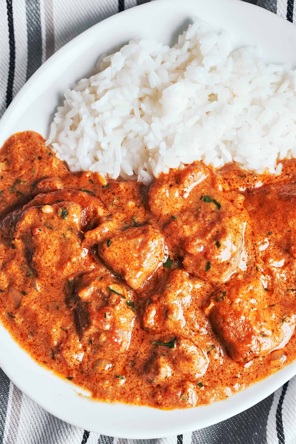 A bowl of creamy peanut butter chicken with a rich, smooth sauce, warm and ready to serve