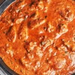 Creamy peanut butter chicken simmering in a rich tomato peanut sauce, thick, glossy, and full of warm, comforting flavor