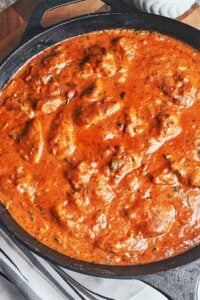 Creamy peanut butter chicken simmering in a rich tomato peanut sauce, thick, glossy, and full of warm, comforting flavor
