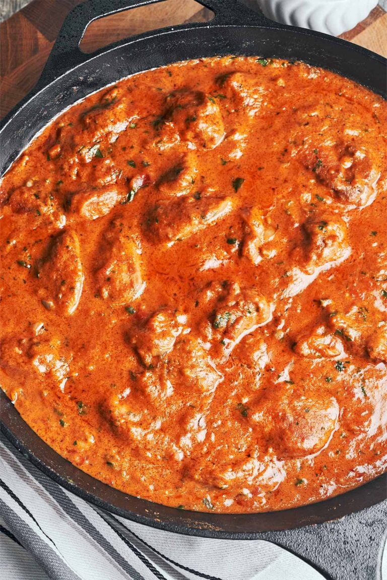 Creamy peanut butter chicken simmering in a rich tomato peanut sauce, thick, glossy, and full of warm, comforting flavor