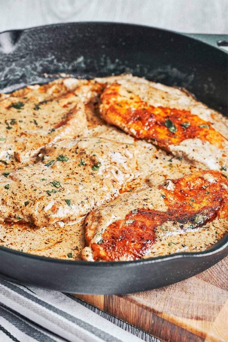 Creamy herb chicken in a skillet with golden seared chicken breasts coated in a rich garlic herb cream sauce and finished with fresh parsley
