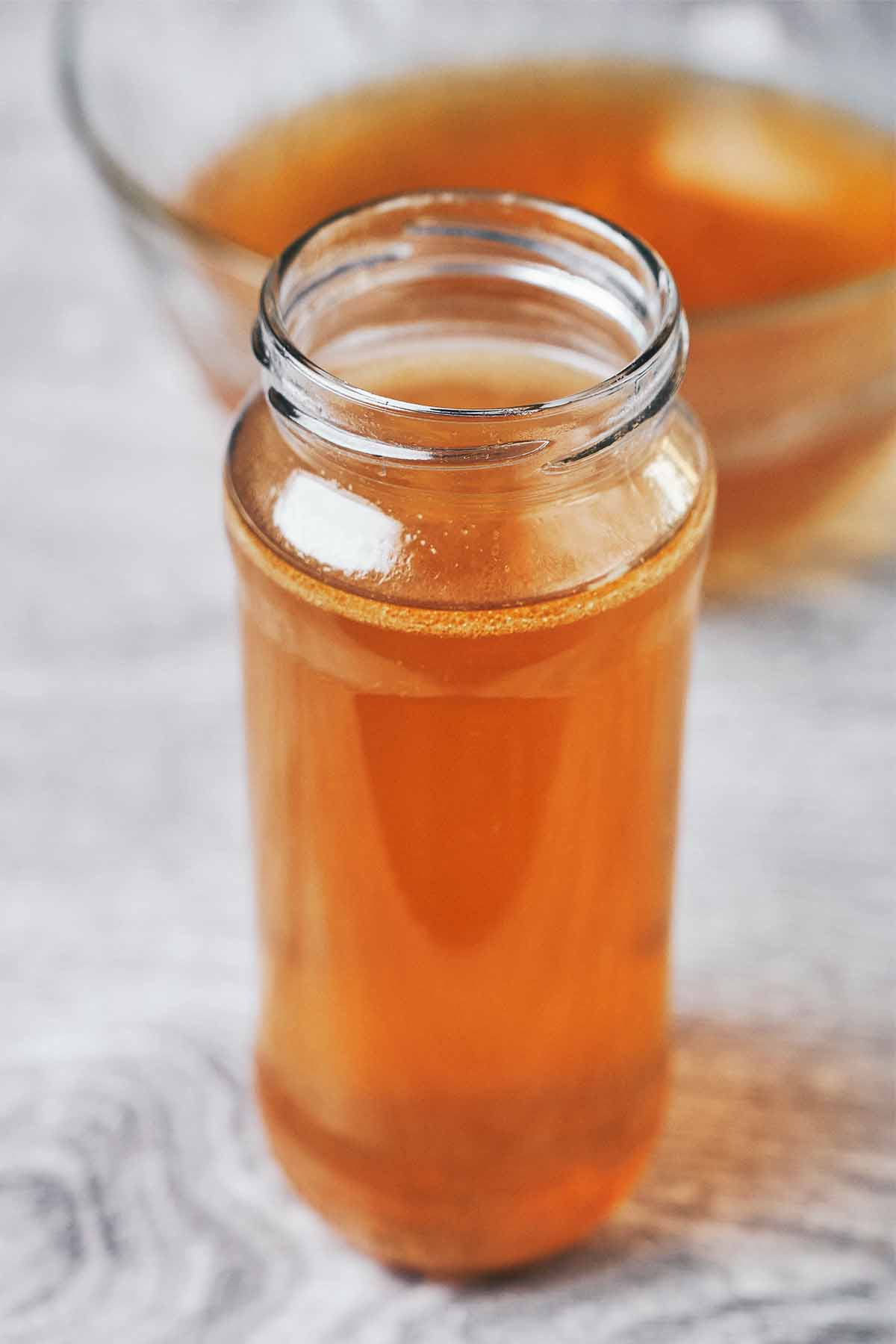 beautiful clear homemade chicken broth showing its deep golden color after slow simmering