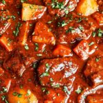 Classic beef stew with tender beef, potatoes, carrots, and rich glossy gravy, finished with fresh parsley.